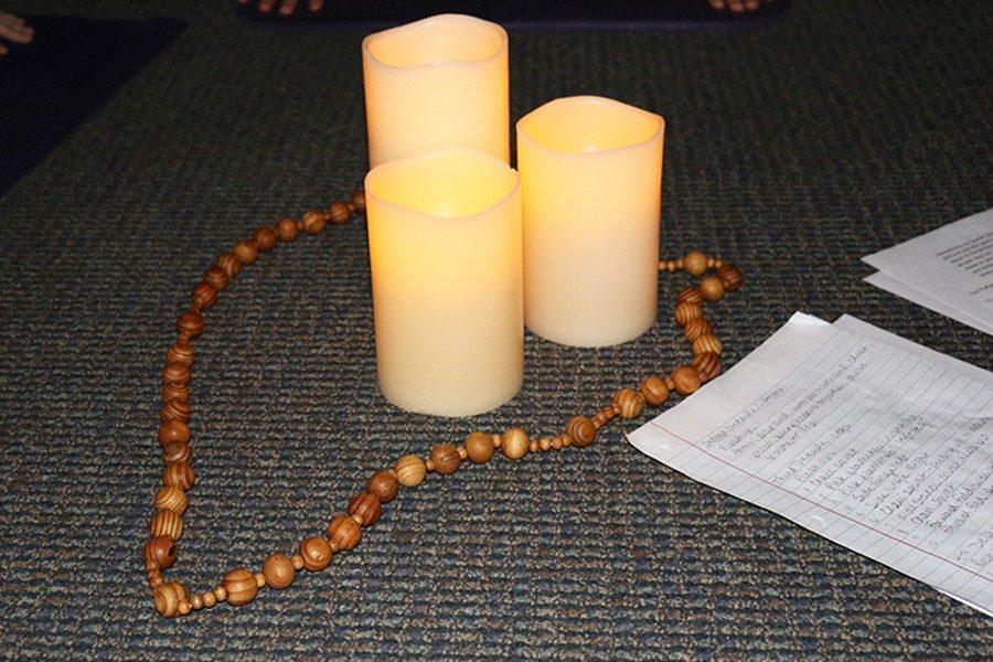 To grow closer to God, students participate in SoulCore circled around a rosary and candles.