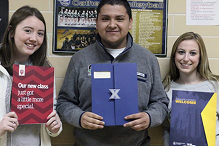 Seniors Sarah Bertrand, Alan Lozano and Lauren Buday hold up their acceptance letters to Indiana University, Xavier University and Marquette University during Flex on March 17. 