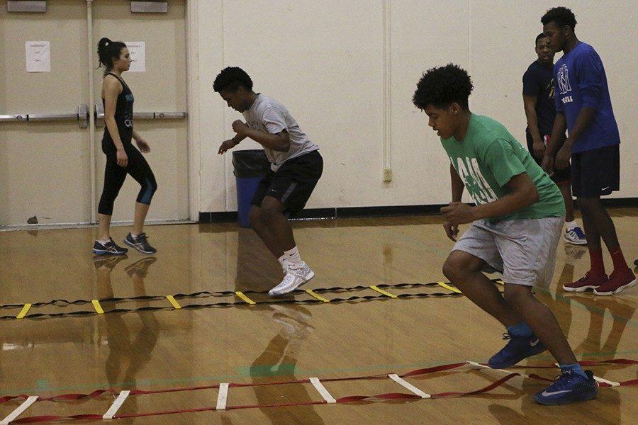 During Tuesday morning’s speed school, participants, including freshman Shiloh Means (in the green T-shirt), take part in the ladder drill, the purpose of which is to improve footwork. 
