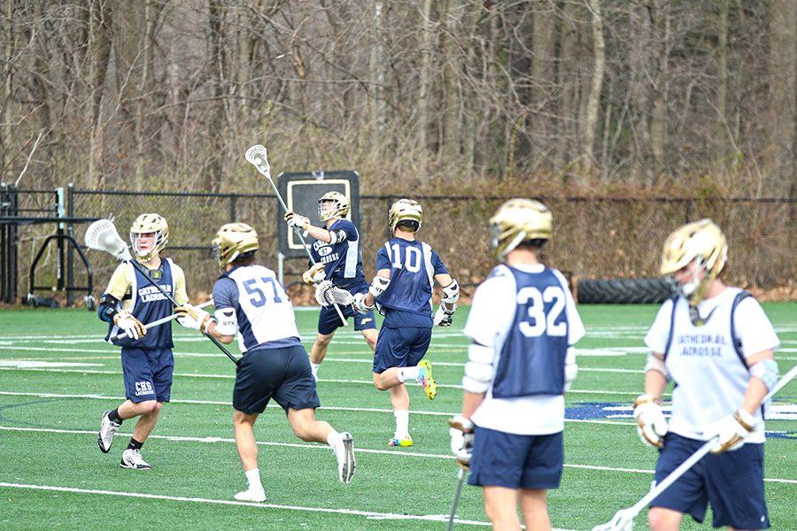 Senior Quentin Carlile catches a pass during a Varsity Boy’s Lacrosse practice on March 9. Carlile will not be able to compete against in-state teams. 

