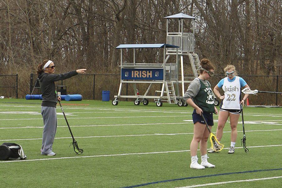 Assistant Coach Mrs. Katie Erbe directs seniors Mallory Johnson, Abbi Sherfick and Taylor Trieloff in a drill last Tuesday.