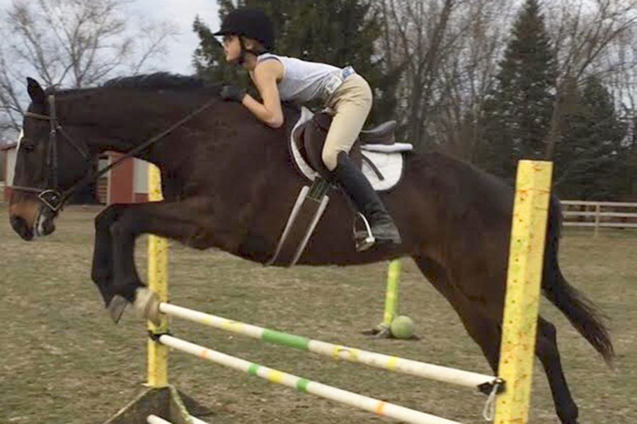 Freshman Diane Houk jumps her horse in preparation for her upcoming competitions. She owns two of her own horses, named Zorro and Double.
