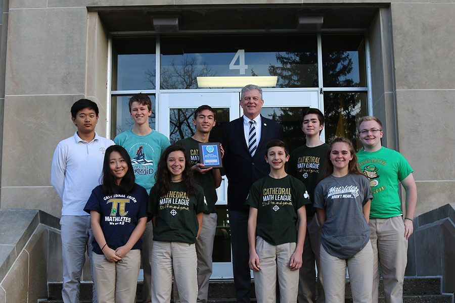 Members of the Regional champion Math League team pose with Principal Mr. Dave Worland at the school's main entrance.