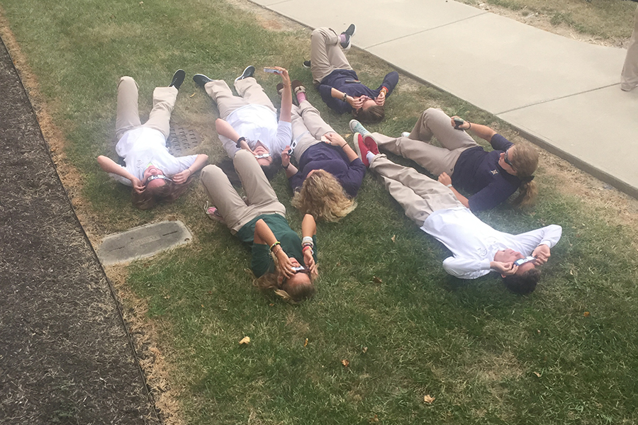 On the lawn outside Loretto, students recline to get the best view of the partial solar eclipse. 