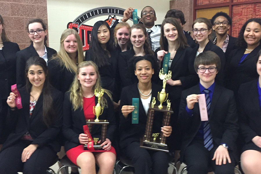 Several members of the speech and debate team show up their ribbons and trophies at last year's State meet.