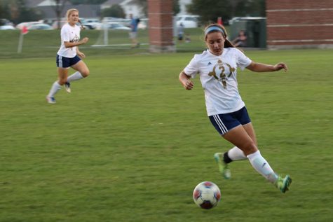 During a regular season match, senior Camryn Wylam moves the ball down the pitch. 