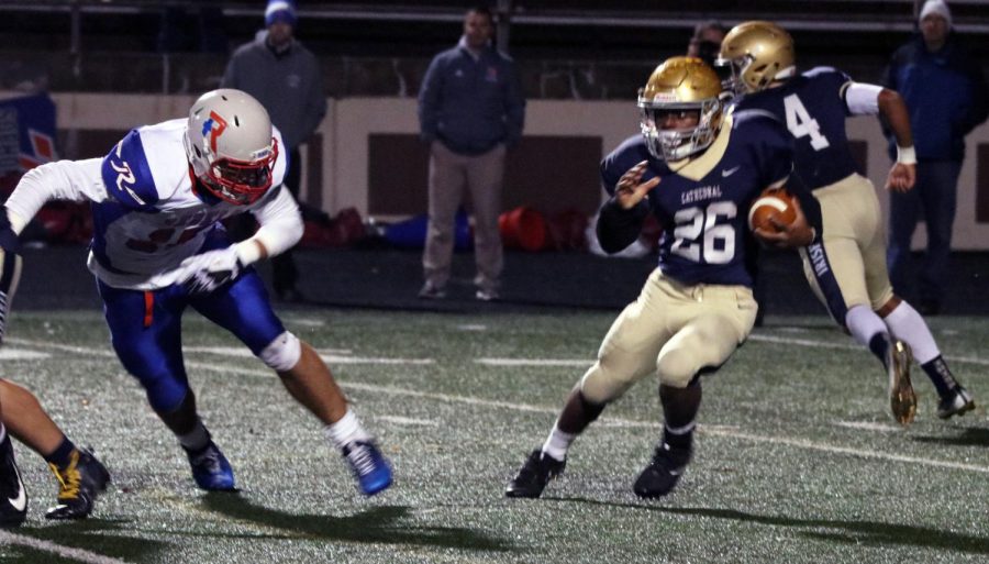 Running back junior ChonDre Bissell (26) gains yardage in the 28-23 Sectional victory over Roncalli after taking the handoff from quarterback sophomore Roman Purcell (4). The Irish take on Decatur Central Nov. 3 at 7 p.m. at Arsenal Tech for the Sectional championship. 