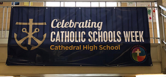 A banner displayed at the student entrance provides a reminder of Catholic Schools Week beginning on Jan. 29.