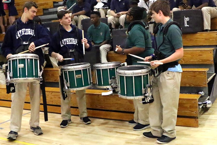 The percussionists, performing during a basketball game in the Welch Activity Center, will take their show on the road when the Pride of the Irish performs in the St. Patrick's Day parade. 