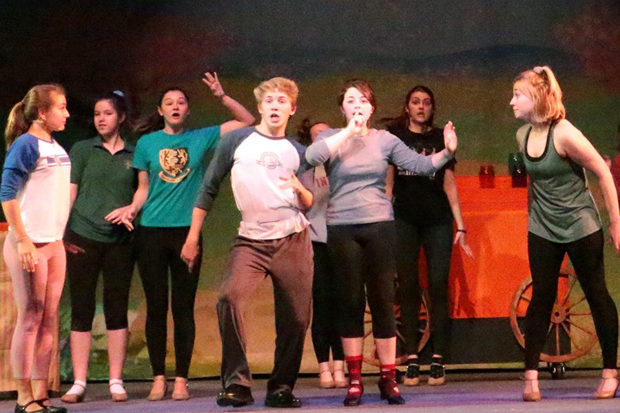 Senior Ethan Gogel leads the cast during a rehearsal of "Mary Poppins."