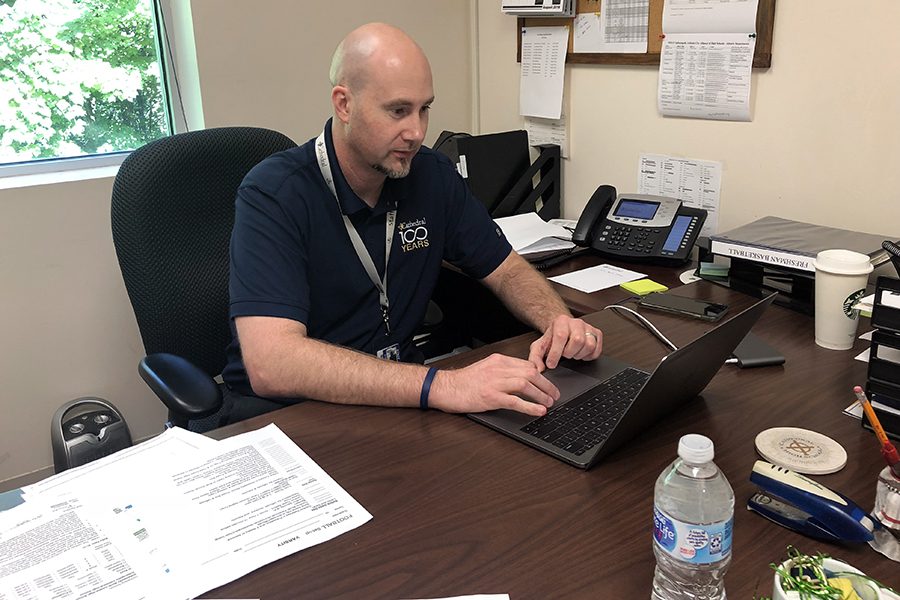 Assistant Athletics Director Mr. Jason Delaney works in his office during G period on Aug. 23