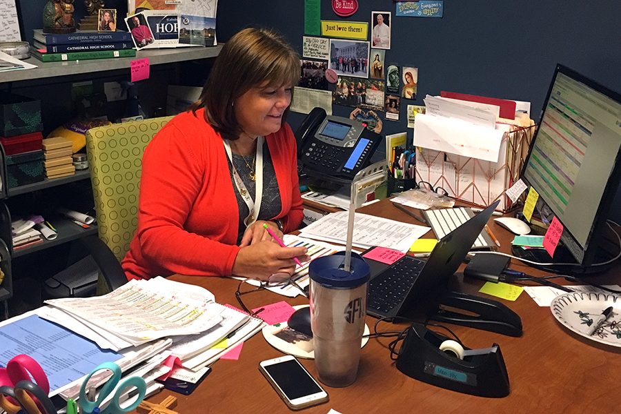 Mrs. Shannon Fox '80, director of Christian service, works in her office during G period on Aug. 28. Fox said a new app for students to track their community service hours is now ready for them to access. 