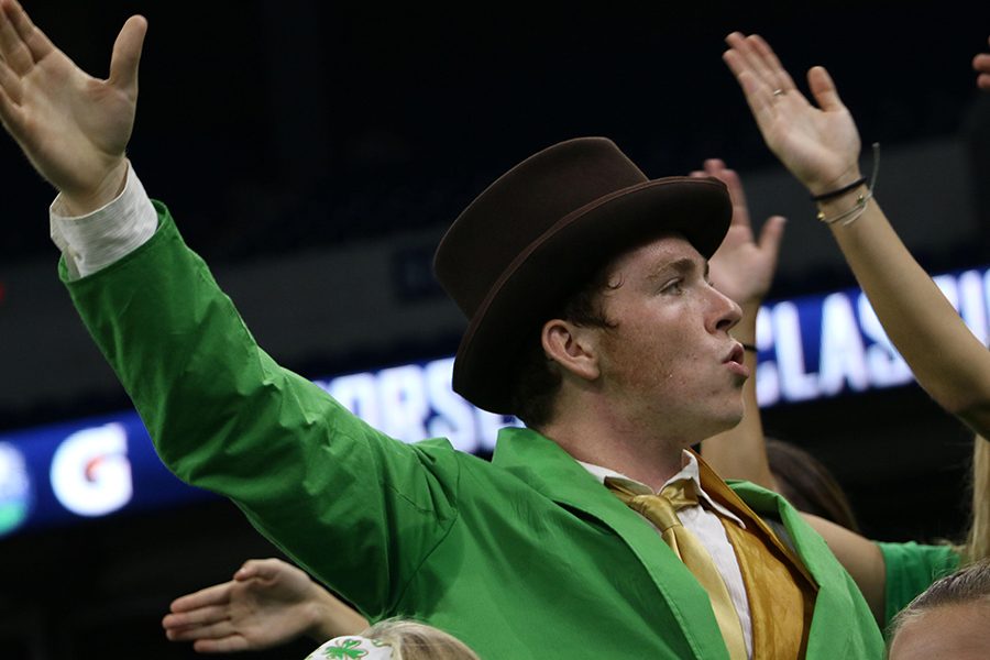 Senior Michael McNulty, in his leprechaun finest, fires up the crowd at Lucas Oil Stadium during the football team's 31-7 win over Noblesville. 