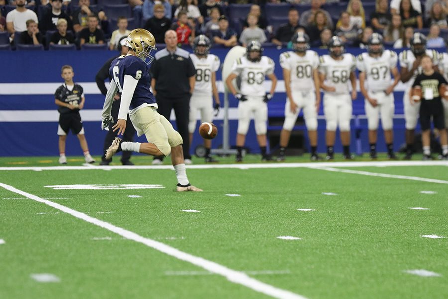 Senior Stuart Gomez punts to the Noblesville offense during the varsity season opener at Lucas Oil Stadium. 