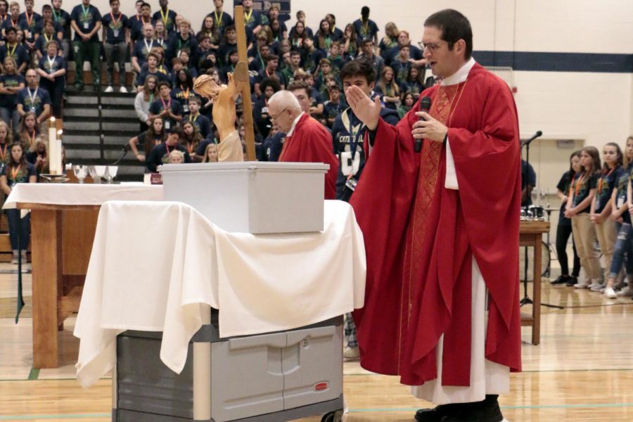 At the Sept. 14 Mass to celebrate the school's 100th birthday, Fr. Eric Augustine '96 blesses the time capsule, which is set to be open in 2068. 