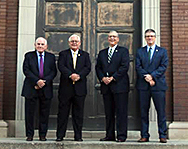 All four men who have served as president of Cathedral High School pose in the same manner as the school's founders 100 years ago. 