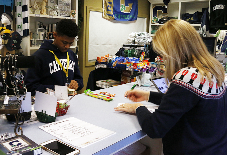 A student makes a purchase at the bookstore during E period on Dec. 5. 