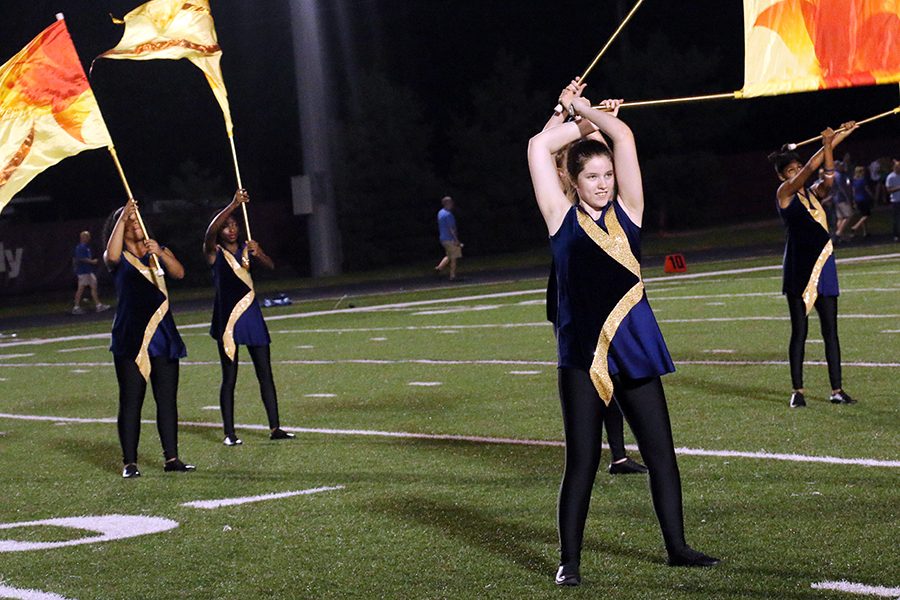 The color guard, shown performing during a football game in the fall, also will be part of the Dec. 9 band Christmas concert. 