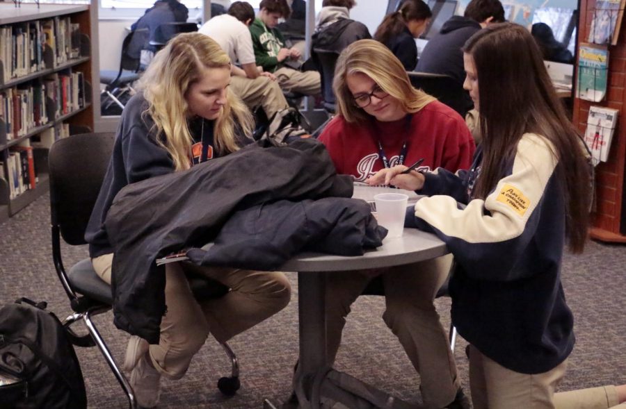 Seniors Oliva Carrico, Grace Brenton and Zoie Obst study during flex. 