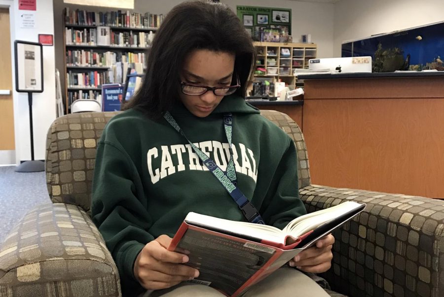 During G period on March 28, junior Lauryn Woods reads in the library. 