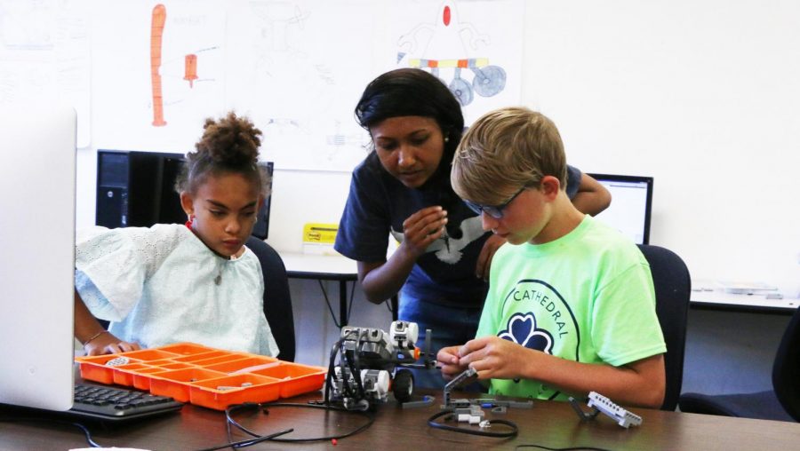 STEM teacher Ms. Ria Periera works with students on a project during last summer's Camp Cathedral. 