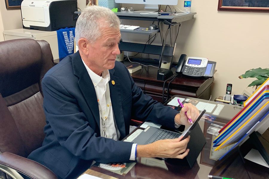 Principal Mr. Dave Worland works at his desk at the start of the school year. 