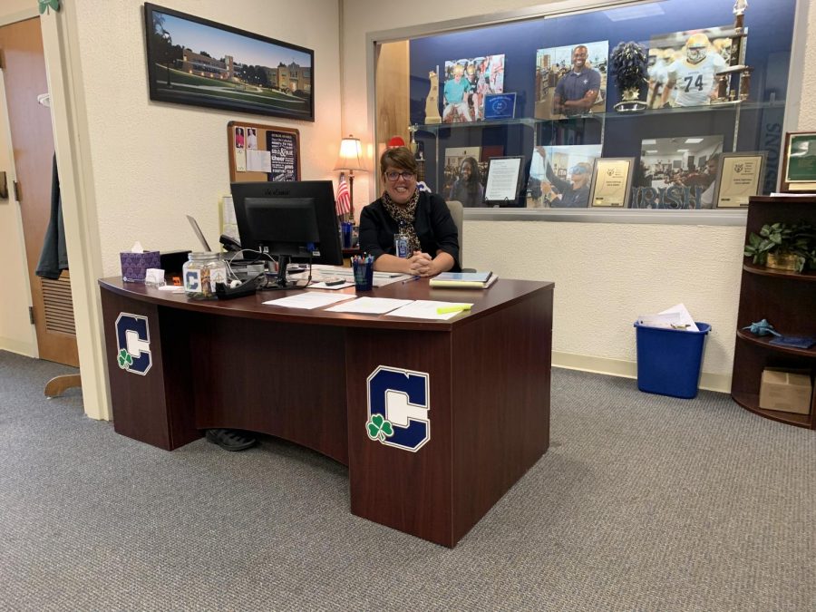 Mrs. Maribeth Cloud works at her desk in the admissions department at the main entrance of Kelly Hall. 