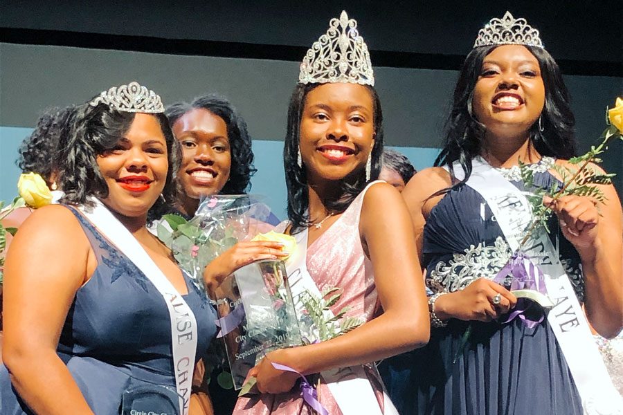 The top three Coronation participants gather on the stage. 