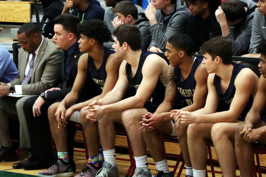 The men's basketball team views the action during last year's Sectional. Tryouts for this year's squad begin Nov. 11. 