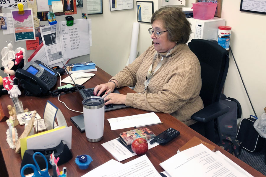 Mrs. Charlene Witka works at her desk in the Shiel Student Life Center. 