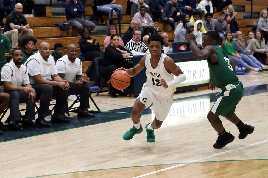 The men's basketball team in action last season against Arsenal Tech. 