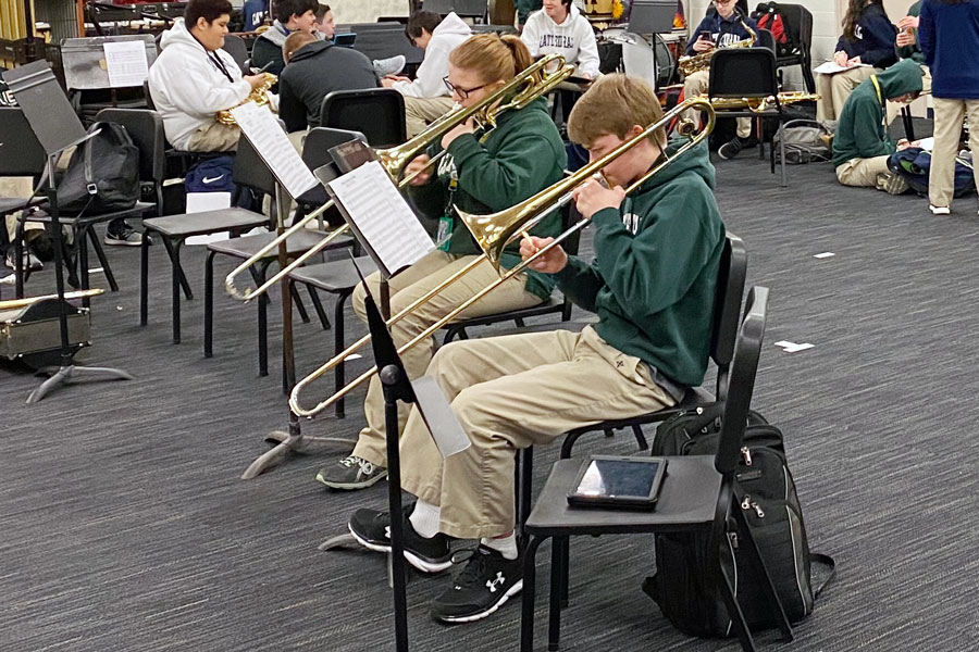 In the band room in the basement of Cunningham Hall, student musicians warm up before a recent practice. 