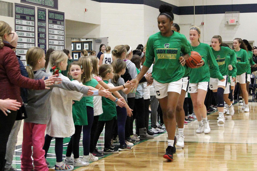 During CYO Night earlier this season, senior Justis Gordon leads the Irish onto the floor in the Welch Activity Center. 