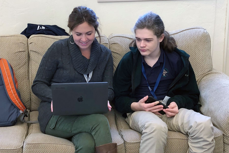 Mrs. Sheila Roberts assists a student with a writing assignment for a class. 