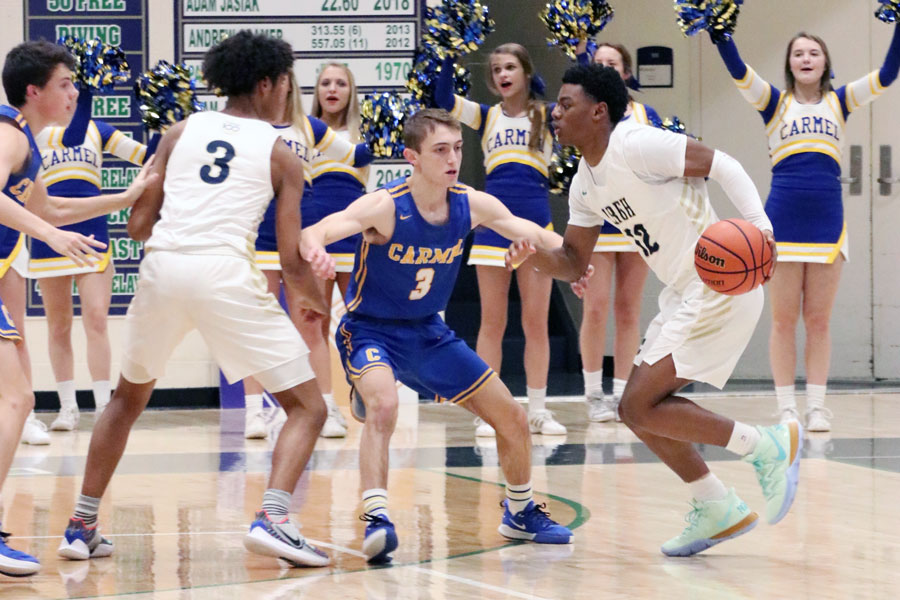 The men's basketball team, shown in action during the regular season game against Carmel, will open Sectional tournament play on March 4. 