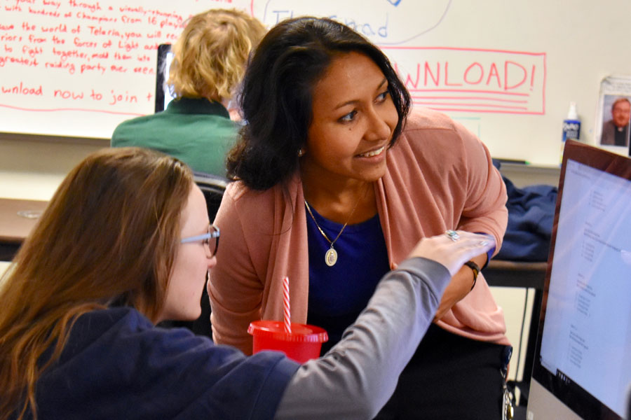 Ms. Ria Pereira assists a student in her E period class on Feb. 17. 