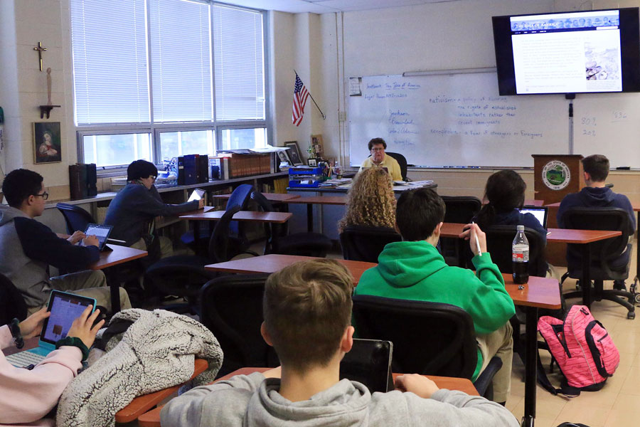 Sr. Mary Ann Stewart, at her desk in her classroom in Kelly Hall, provided her thoughts about the current coronavirus pandemic and its historical significance. 