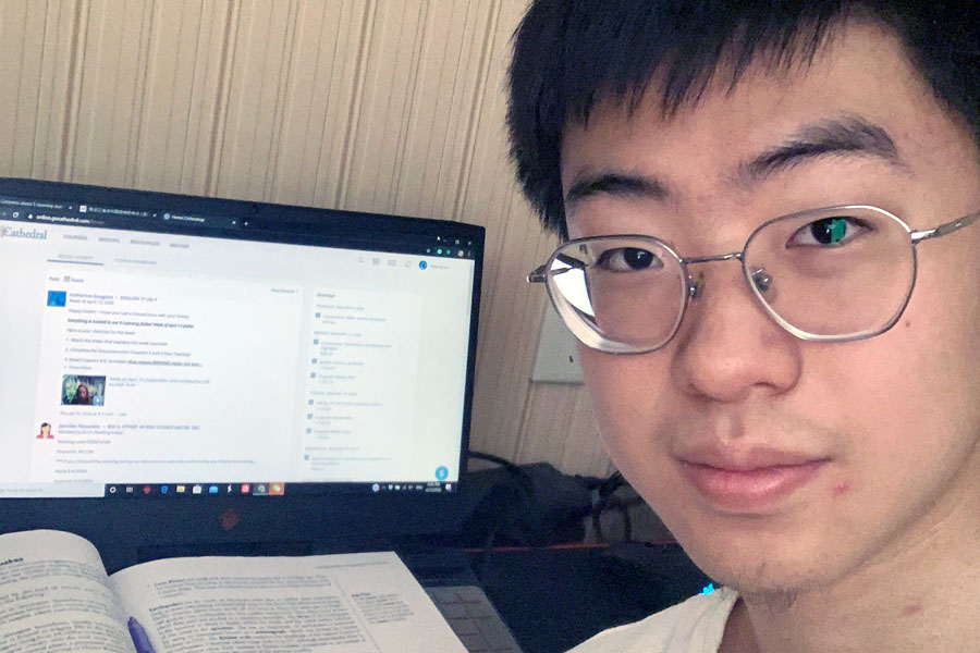 Junior Deviin Liu works on his Scholoogy assignments in his hotel room in China, where he is in quarantine for 14 days. 