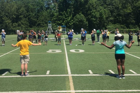 The drum majors lead a recent Pride of the Irish practice on the football field. 