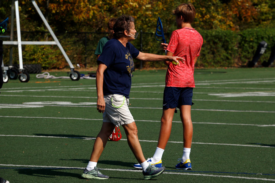 Health teacher Ms. Rhonda Low gives directions during a PE class on the football field. 