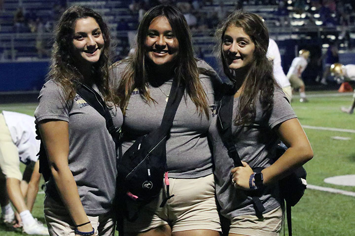 Football managers, from left, seniors Lisa Fallouh, Eilya Mayo and Julia Reasginer, have adjusted to changes in the routines due to the Covid-19 pandemic. 