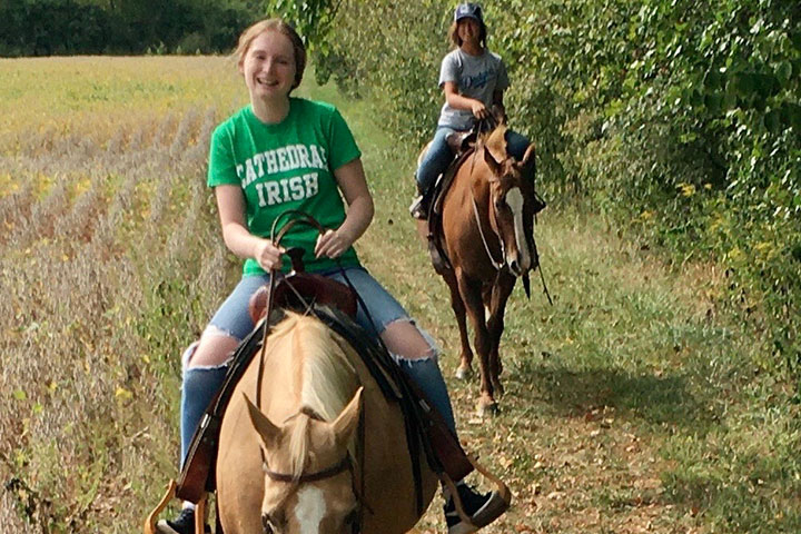 Members of the Horse Club are riding in pairs to be sure to maintain social distancing. 