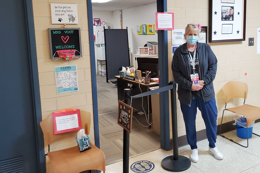 School nurse Mrs. Marianne Vogt stands outside her office on the first floor of Kelly Hall.