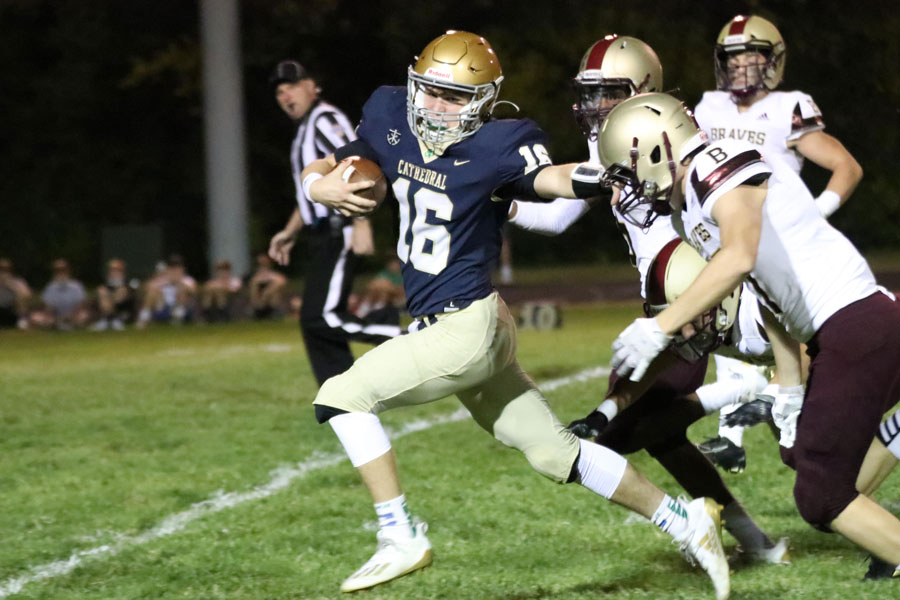 Senior quarterback Nathan McCahill escapes the Brebeuf Jesuit defense during the Homecoming game. 