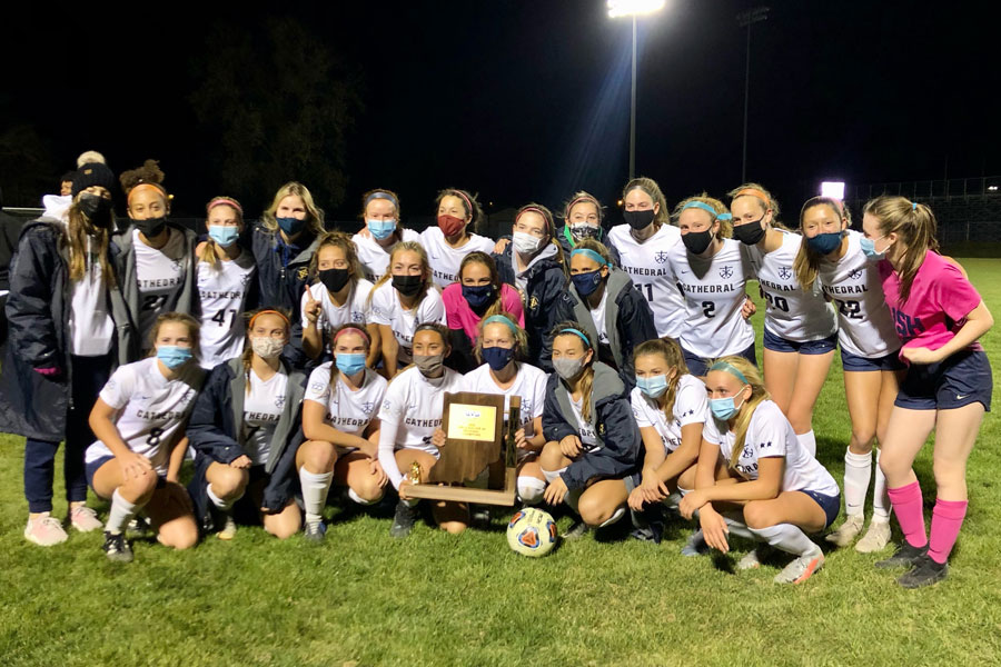 The State-bound womens soccer team shows off its Regional champion trophy. 