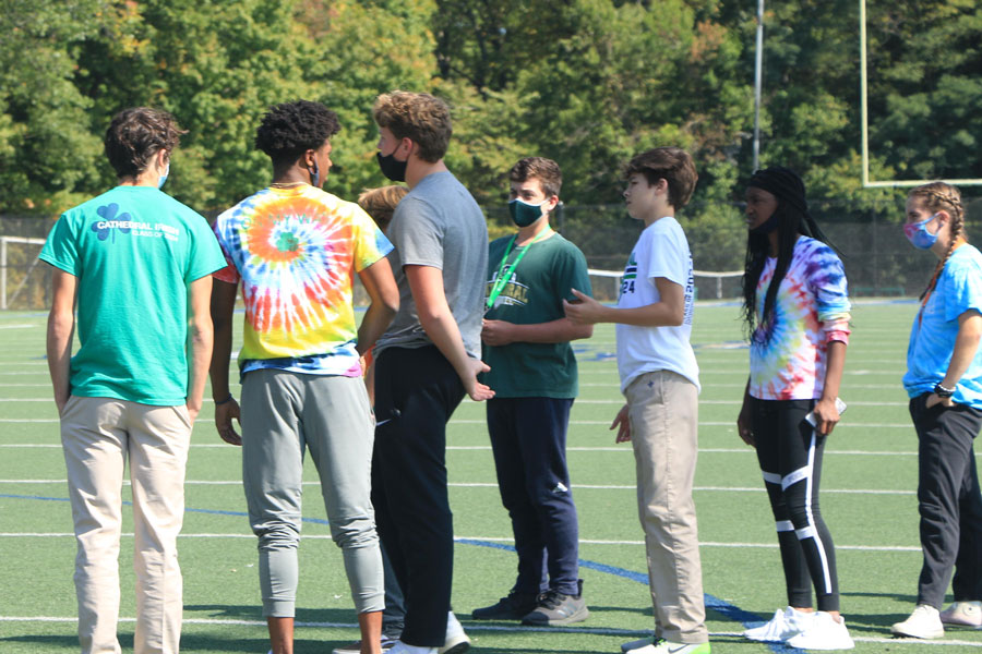 Earlier in the school year, senior peer mentors gathered with the freshmen on the football practice field. 