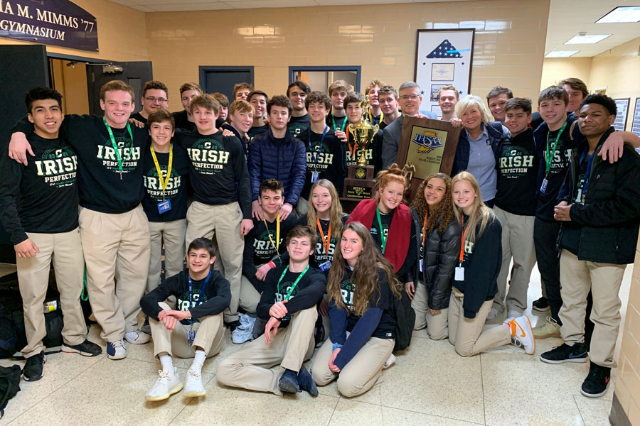 Last year's wrestling team shows off the 2020 State championship trophy. 