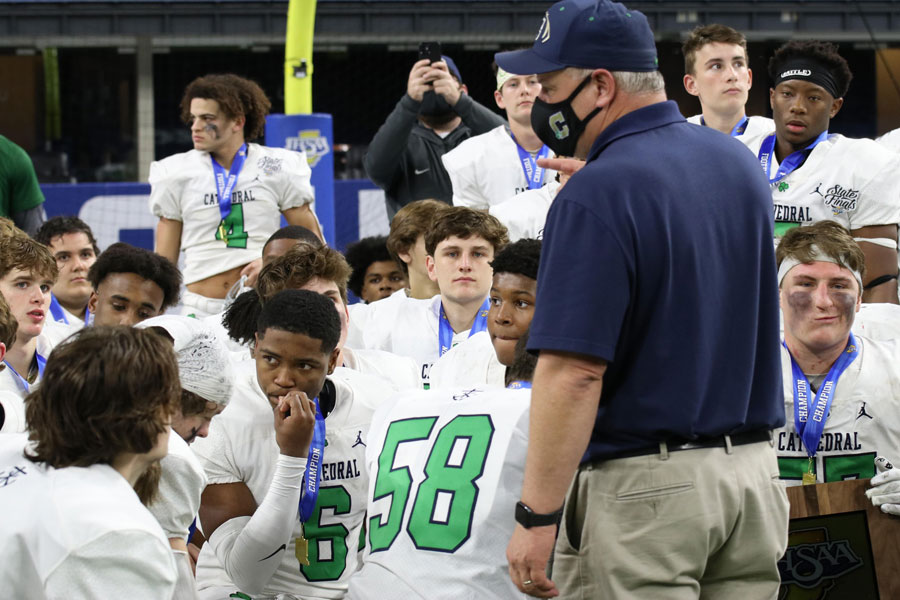 On the field at Lucas Oil Stadium, Head Coach Mr. Bill Peebles '88 address the team after the presentation of the State championship trophy. 