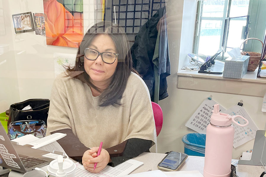 Behind a clear divider on her desk in her classroom in Loretto Hall, English teacher Mrs. Lisa Blamey prepares to teach a class. Blamey, who serves as the co-moderator of the Junior Class, says no definitive plans for prom this spring are set in stone at this point.