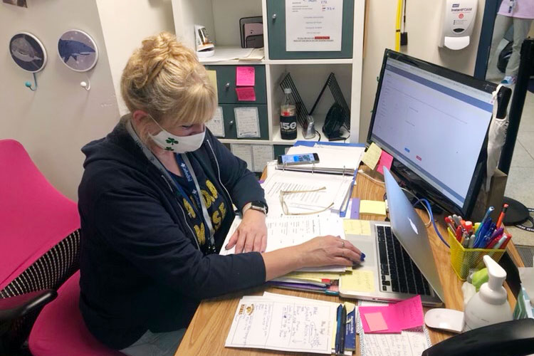 School nurse Mrs. Marianne Vogt '86 wears a single cloth mask in her office in Kelly Hall. 